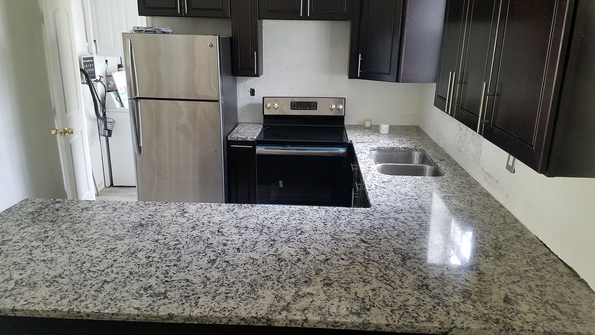Close-up of polished granite counters and custom kitchen cabinetry